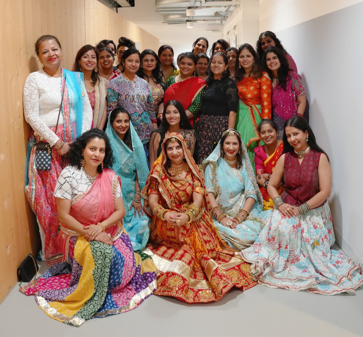 Women in colourful traditional dress gathered for a group photograph